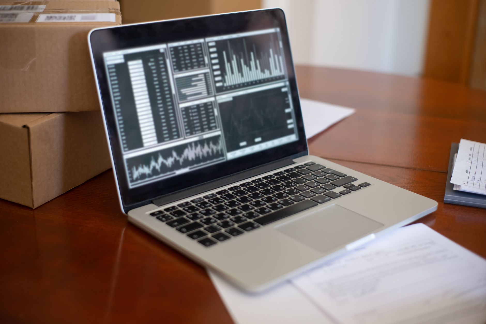 Business owner doing bookkeeping with AI on a laptop
